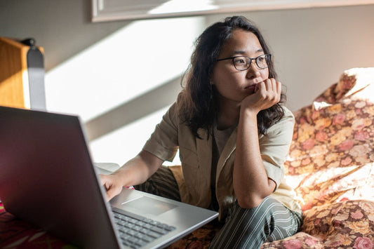 A distracted person by a laptop.